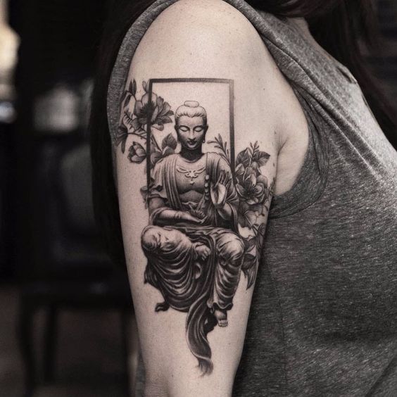A sitting and meditating Buddha shoulder tattoo