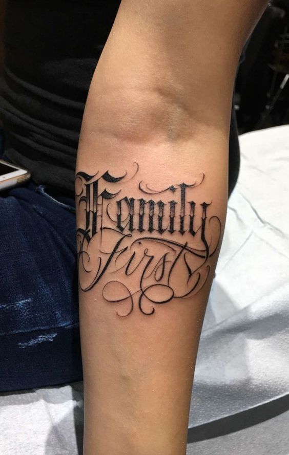 Forearm Chicano text tattoo