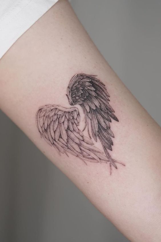 15 examples Angel wings tattoo on arm as symbol of protection