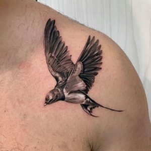 15 graceful and timeless black swallow tattoo for men and women 13