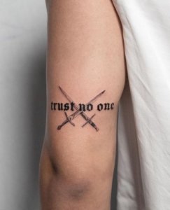 Trust No One lettering tattoo is a powerful message on the arm 5