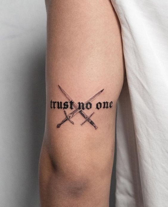 Trust No One lettering tattoo is a powerful message on the arm