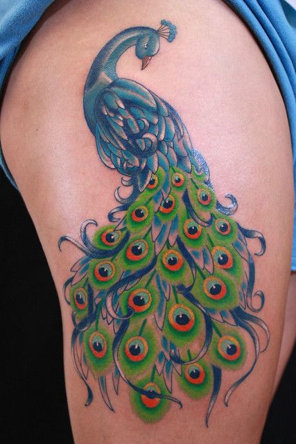 10 stunning peacock tattoos on the thigh a symbol of beauty and grace 9