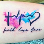 A lettering tattoo of Faith, Hope, and Love with heartbeat
