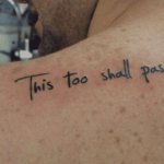 Shoulder tattoo with a “This Too Shall Pass” lettering and meaningful message
