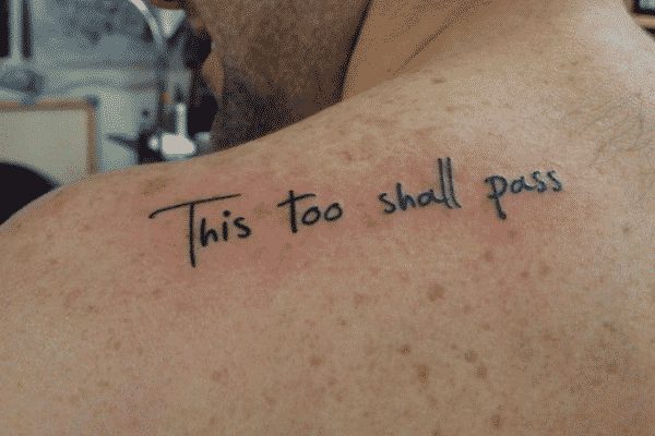 Shoulder tattoo with a “This Too Shall Pass” lettering and meaningful message