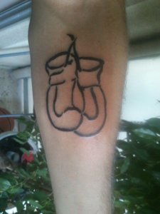 Simple boxing gloves tattoos A symbol of strength and resilience 1