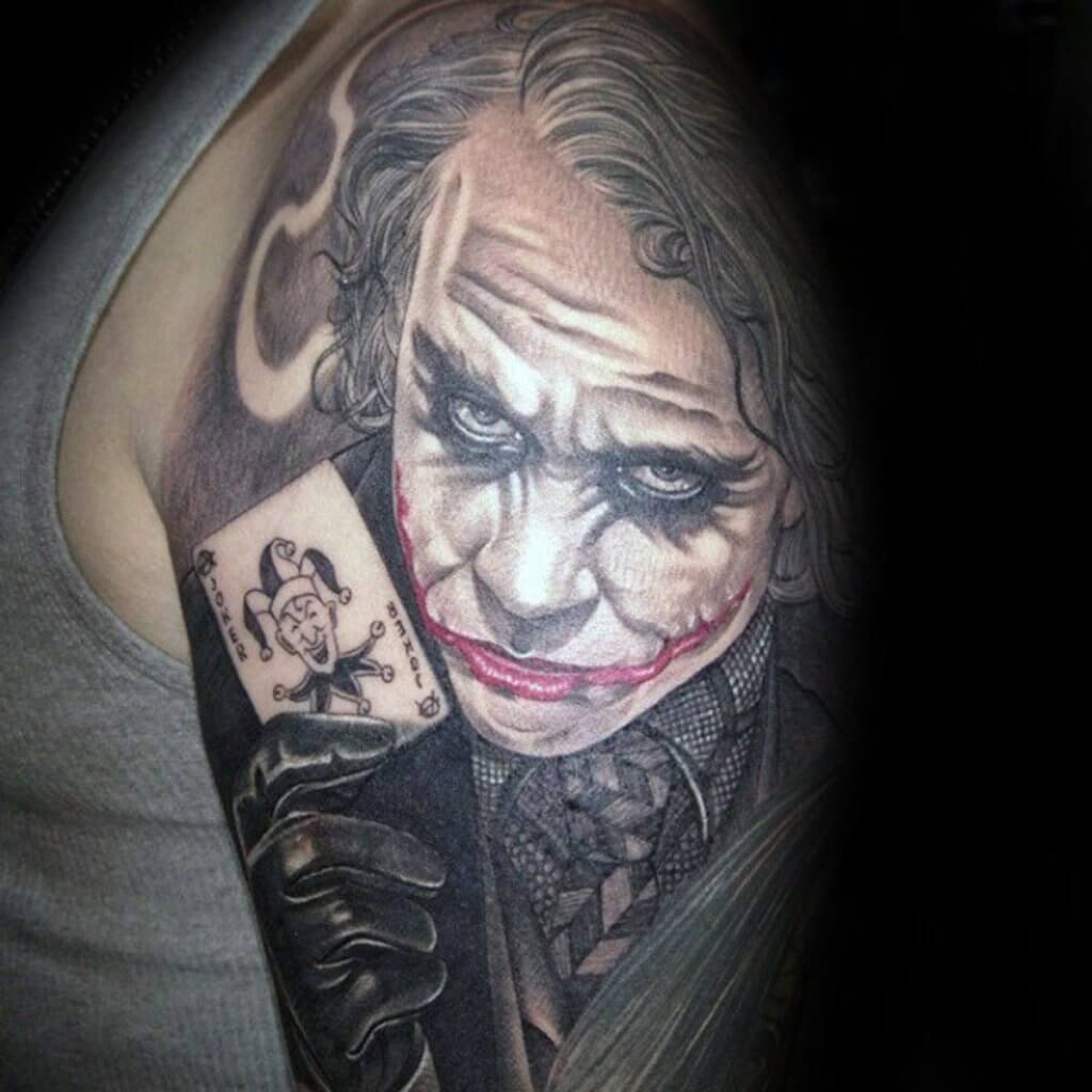 Mesmerizing Joker card shoulder tattoo design with famous movie Jocker character.