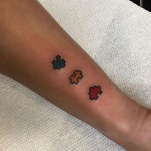 Small forearm Puzzle Piece Tattoo